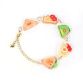 Custom acrylic charm bracelet with colorful sandwich designs and gold chain on white background