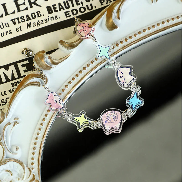Custom acrylic connection bracelet with pastel cartoon charms and stars on ornate mirror.