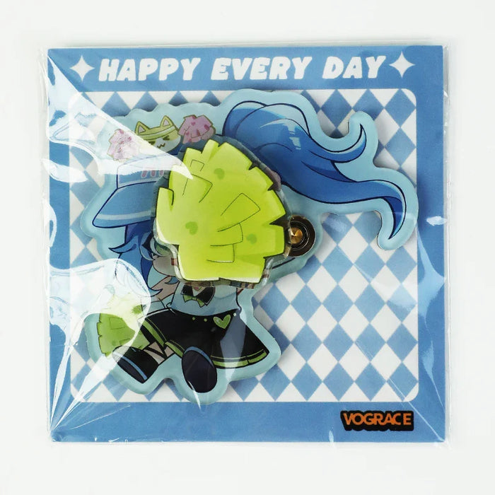 Acrylic keychain of a blue-haired cheerleader with green pom-poms on diamond pattern backing.