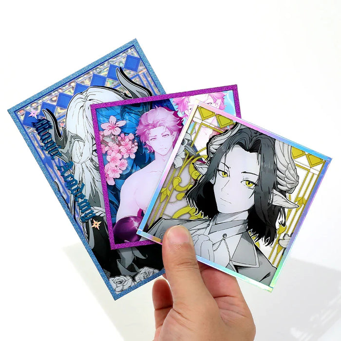 Hand holding custom acrylic holographic art boards with anime-style fantasy characters