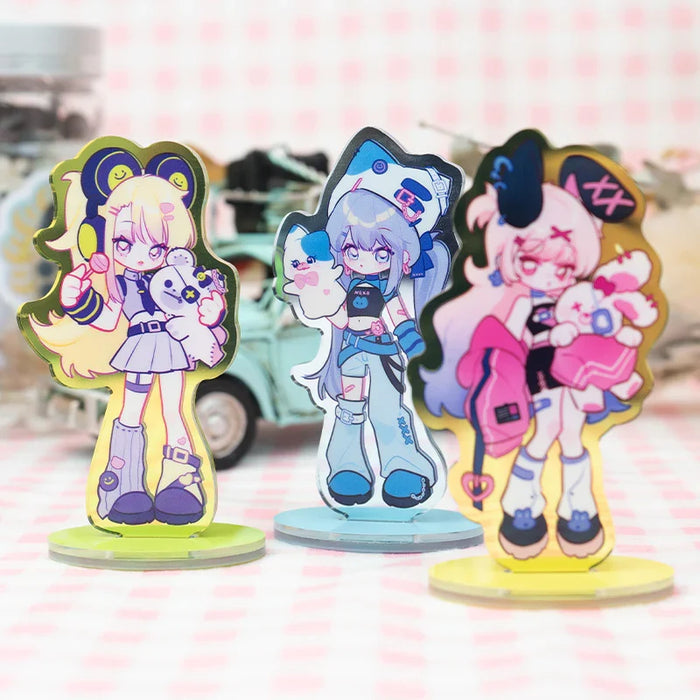 Custom acrylic anime standees with colorful characters on clear bases, displayed on table