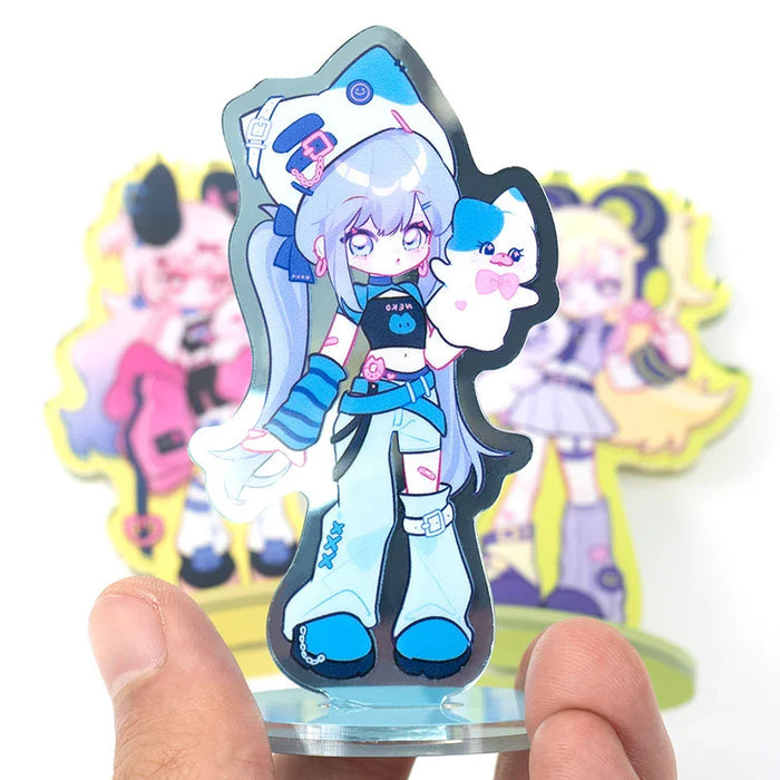 Custom acrylic anime character standee with pastel colors, held by hand, blurred standee in background