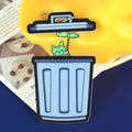 Custom acrylic magnet charm shaped like a trash bin with a green cat plant design