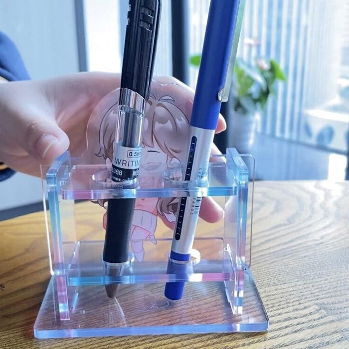 Custom acrylic pen holder with anime design holding two pens on a wooden desk