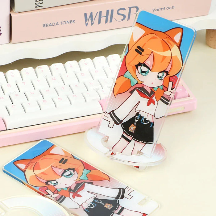 Custom acrylic phone holder with cute anime girl design on a desk near a keyboard