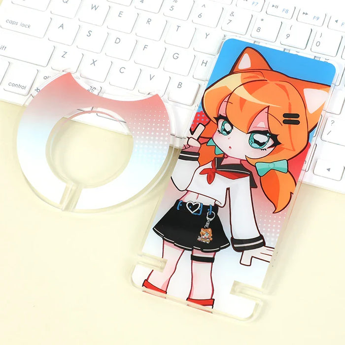 Custom acrylic phone holder with anime girl design on desk near a keyboard