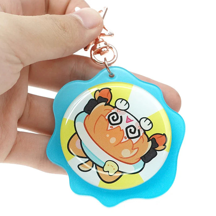 Hand holding custom acrylic double-sided rotating keychain with cute cartoon design and blue border