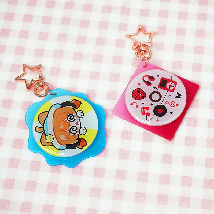 Custom acrylic double-sided rotating keychains with star clasps on pink checkered fabric