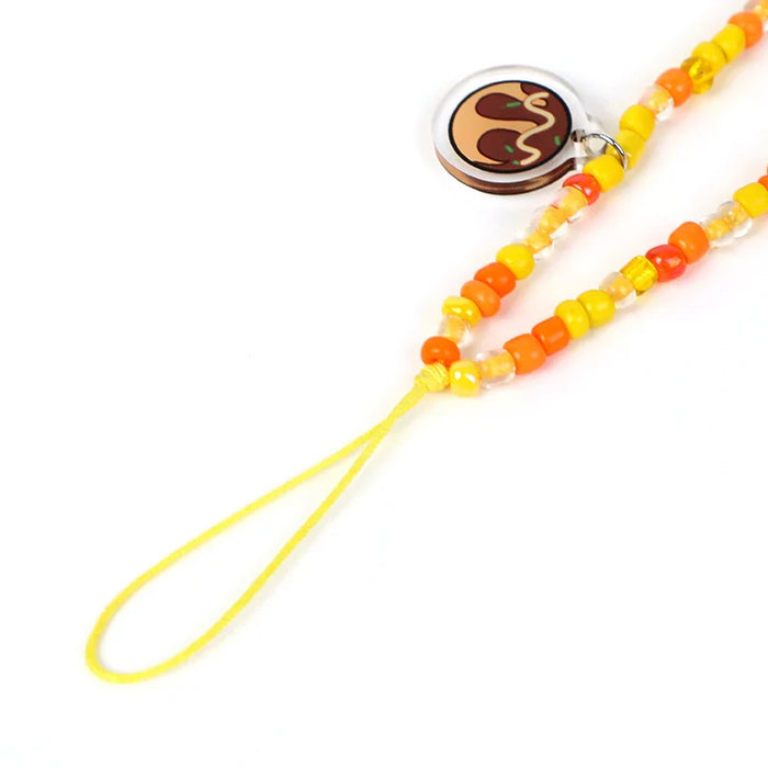 Colorful custom beaded acrylic phone charm with yellow and orange beads and a cartoon charm.