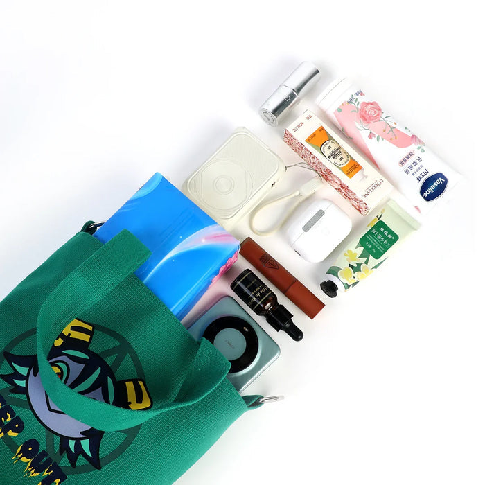 Green custom canvas bucket bag with colorful contents including cosmetics, skincare, and accessories