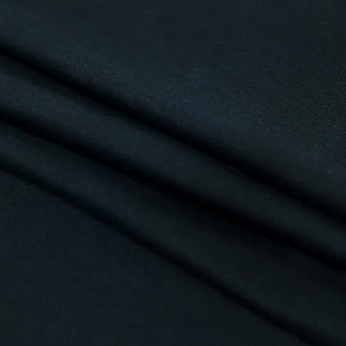 Close-up of black cotton crew neck t-shirt fabric, soft and smooth texture.