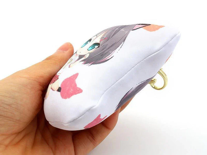Hand holding a custom anime dakimakura body pillow keychain with character illustration