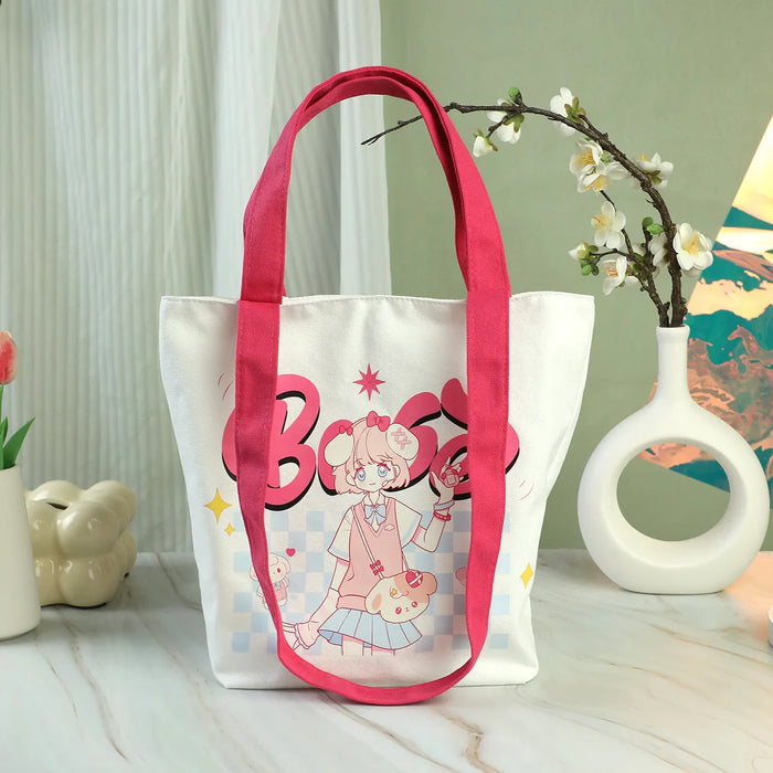 Custom canvas tote bag with pink straps and cute anime girl print, displayed on marble table