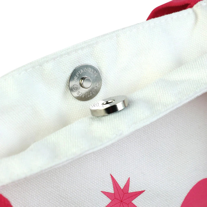 Close-up of canvas tote bag with magnetic snap closure and pink star design