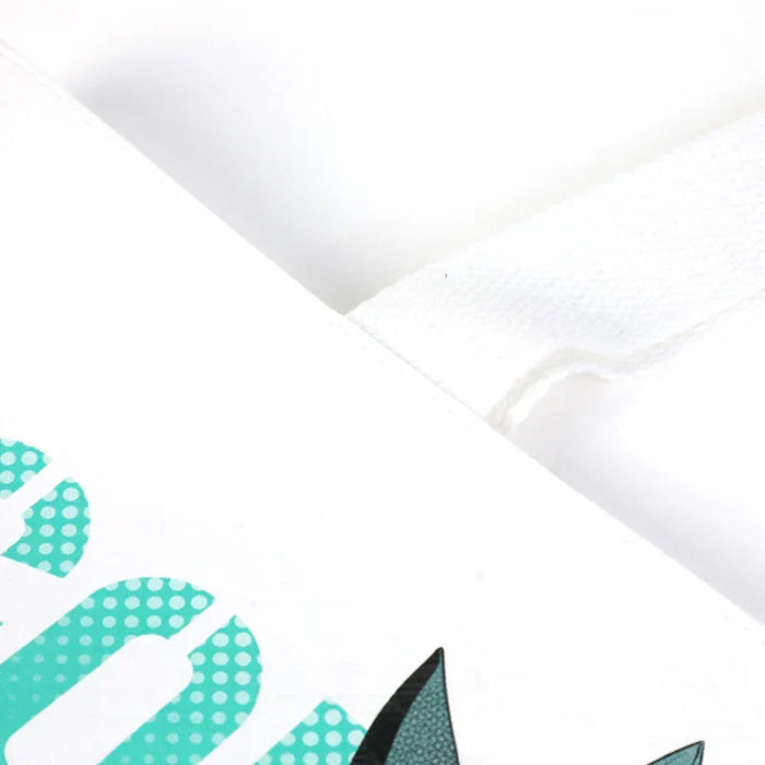 Close-up of a white custom DuPont paper tote bag with teal dotted print and sturdy handle