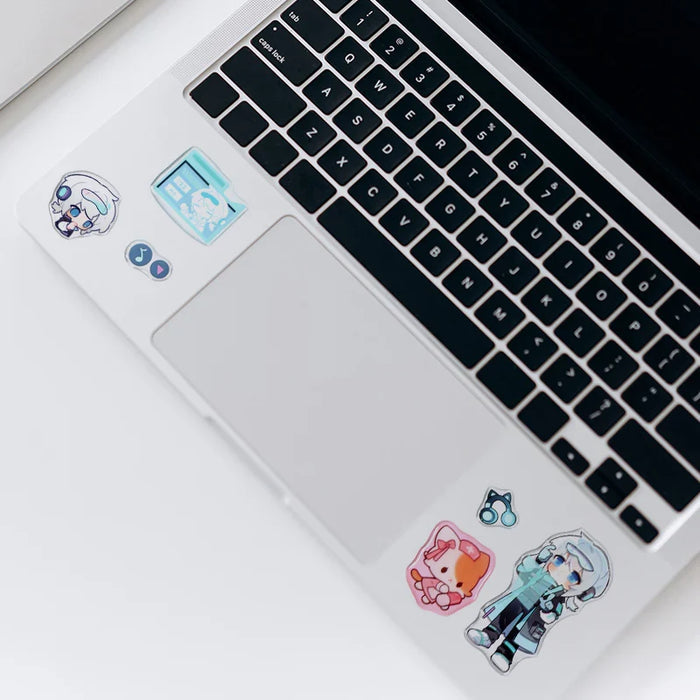 Cute anime stickers on laptop, featuring chibi characters and music icons for personalization.