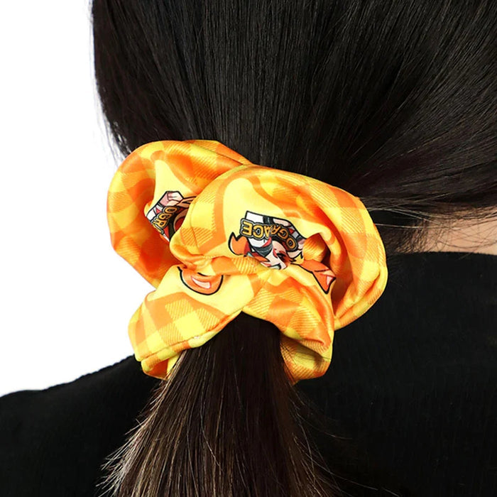 Yellow custom printed hair tie with cartoon design securing dark hair in a ponytail