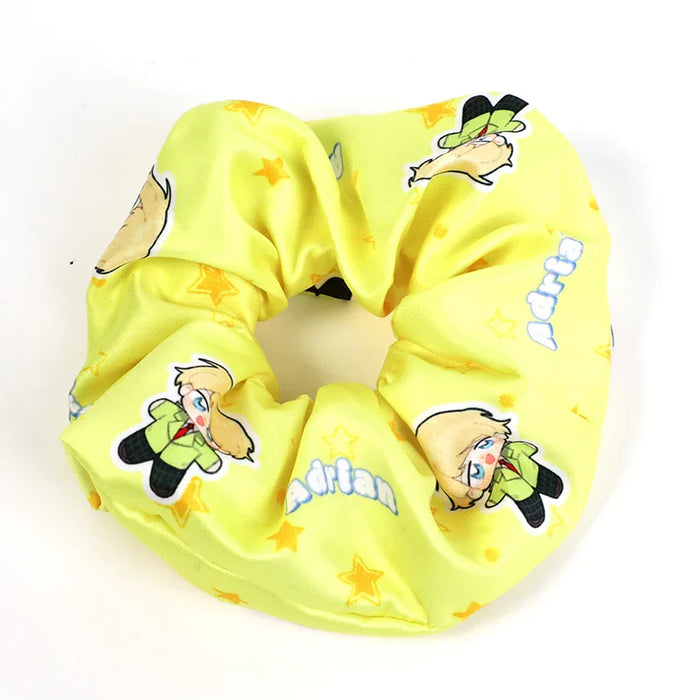 Custom yellow hair tie scrunchie with cartoon character and star patterns, text Adrian