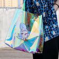 Custom holographic tote bag with cute anime bunny design, held outdoors.
