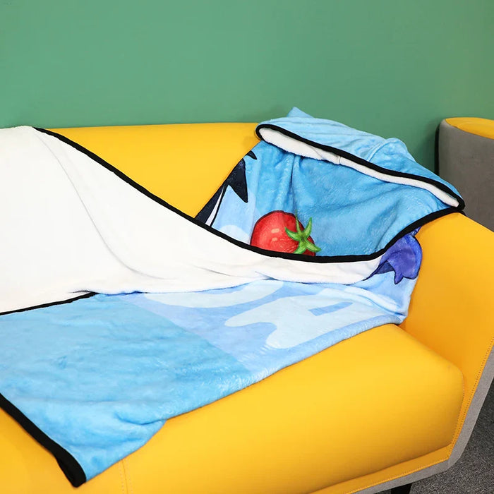 Custom blue hooded blanket with cartoon print draped on yellow sofa