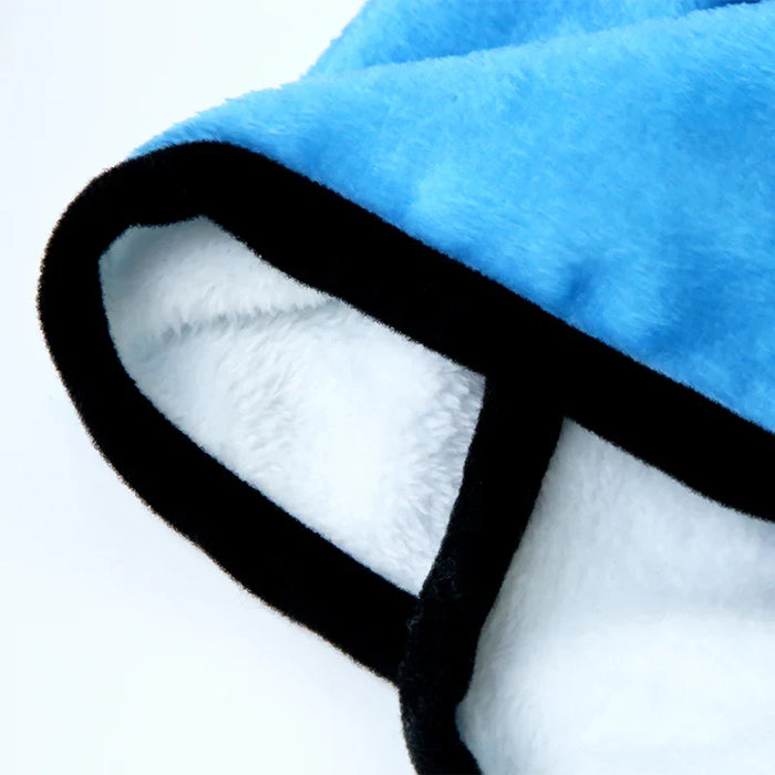 Close-up of a soft blue and white fleece hooded blanket with black trim
