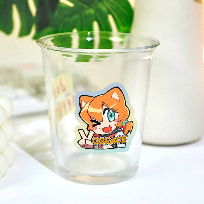 Custom kiss cut anime sticker with orange-haired cartoon character on a clear glass cup