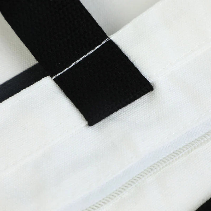 White canvas tote bag with black strap and zipper detail, ideal for custom merch and promotional gifts.