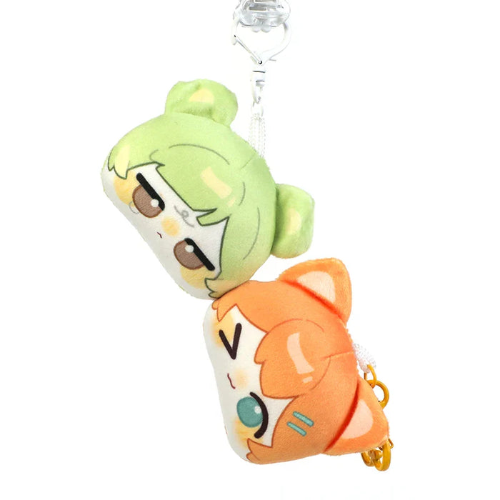 Cute anime plush keychains with green and orange character designs, perfect for anime merch collectors.