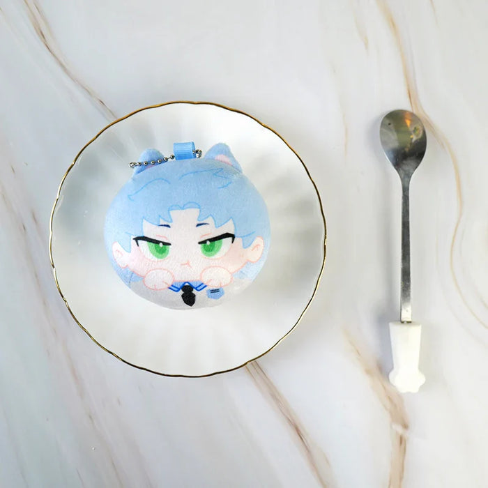 Round blue custom anime plush toy with cat ears in a white dish, spoon beside on marble surface.
