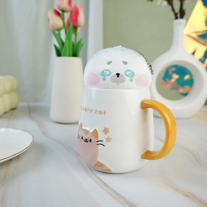 Cute animal plush keychain in a ceramic cat mug with yellow handle on a marble tabletop