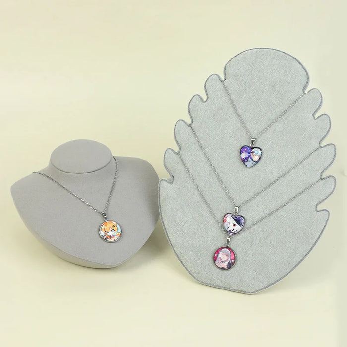 Anime-themed necklaces with colorful character pendants displayed on gray stands