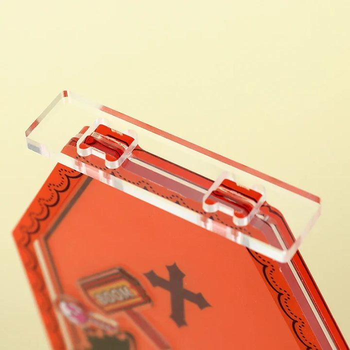 Close-up of custom openable acrylic shaker standee with red printed design and cross symbol