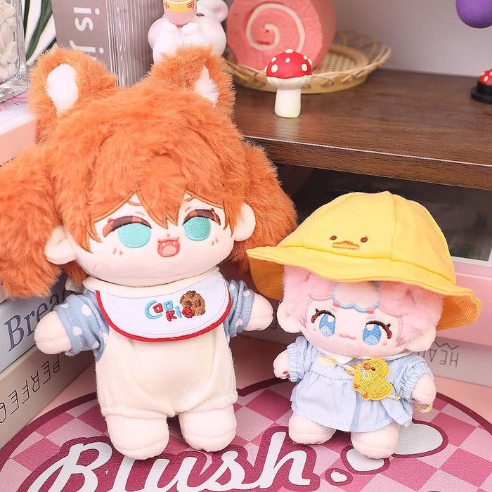 Two cute custom plush dolls with big eyes, one with orange hair and animal ears, one in a yellow hat