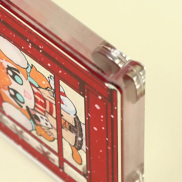 Close-up of custom acrylic fridge magnet with animated character in red frame and quicksand liquid effect.