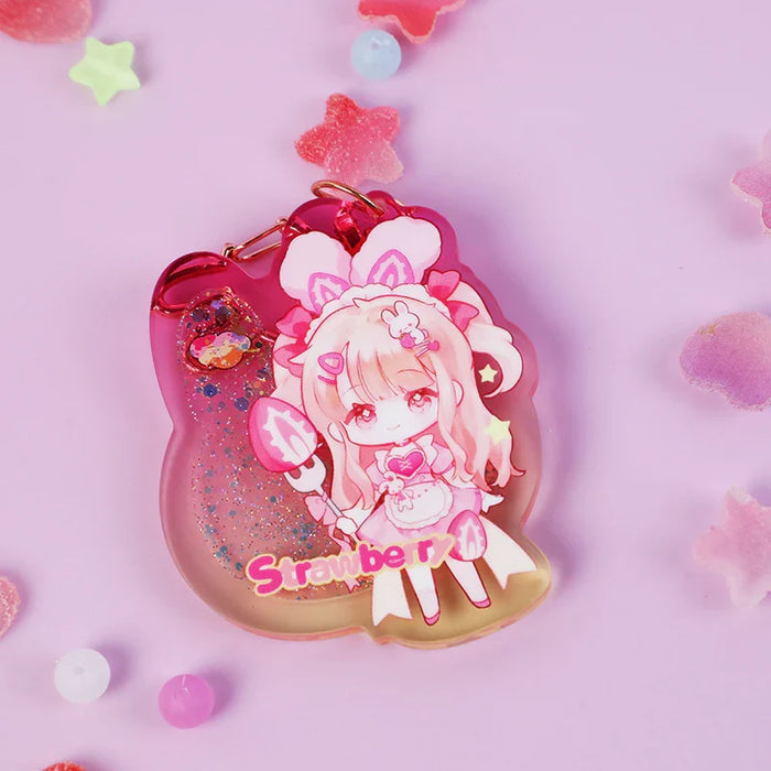Custom acrylic quicksand liquid keychain with pink anime girl, glitter, and strawberry text on a pastel background.