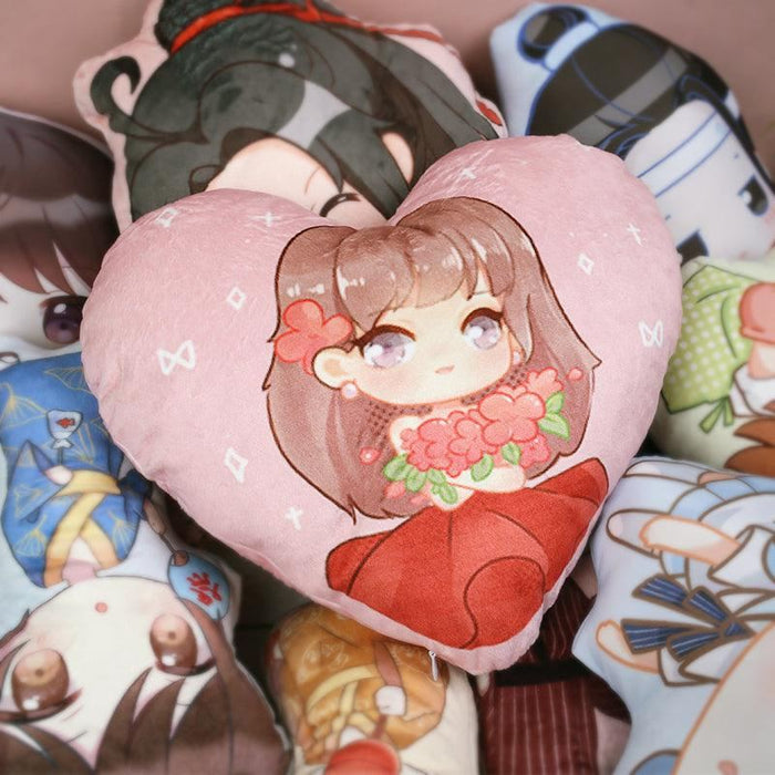 Custom-shaped anime throw pillows with colorful chibi character designs, heart pillow in front