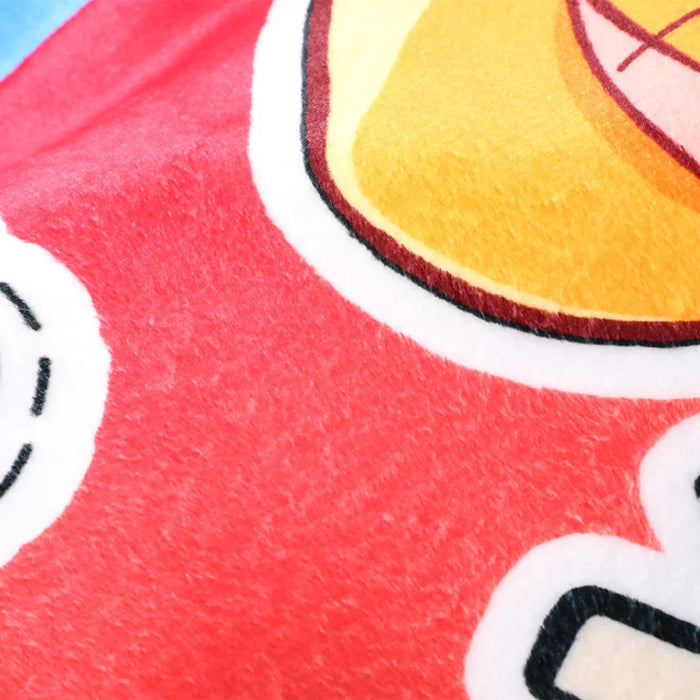 Close-up of custom coral fleece blanket with colorful printed cartoon design