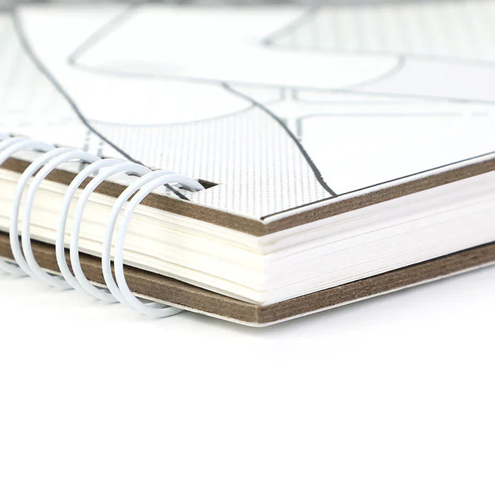 Close-up of a custom spiral-bound sketchbook with thick pages and printed cover design