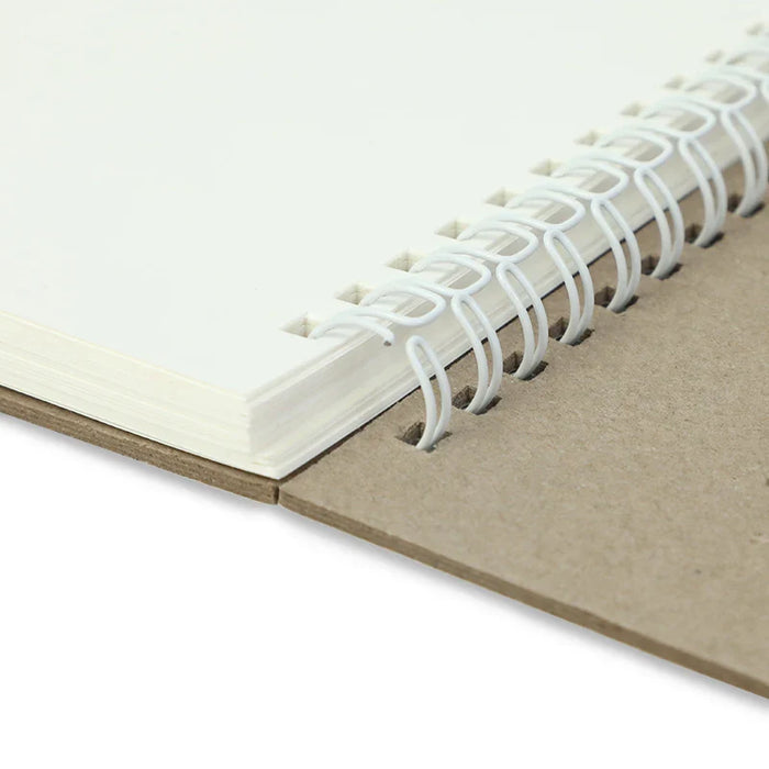 Close-up of spiral binding on blank custom sketchbook with kraft cover