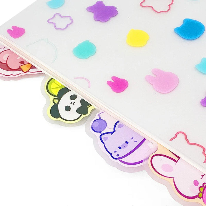 Close-up of a spiral notebook with colorful animal-shaped tabs and pastel pattern dividers