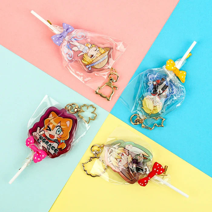 Custom acrylic lollipop charms with anime characters, colorful bows, and gold keychain clasps
