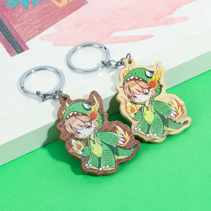 Cute anime boy dragon costume wooden acrylic keychains on green background