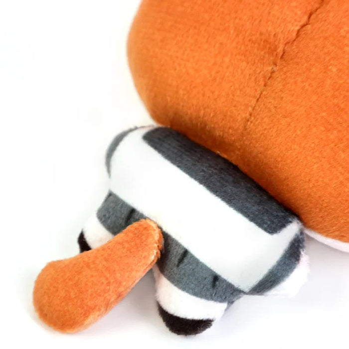 Close-up of a custom plush toy with orange tail and striped gray and white legs