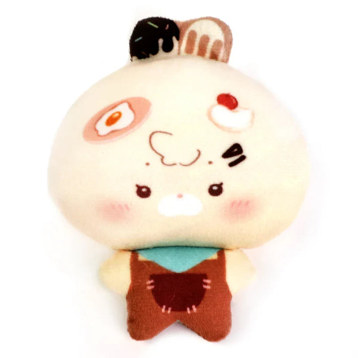 Custom plush toy keychain shaped like a cute character with food-themed face and overalls.