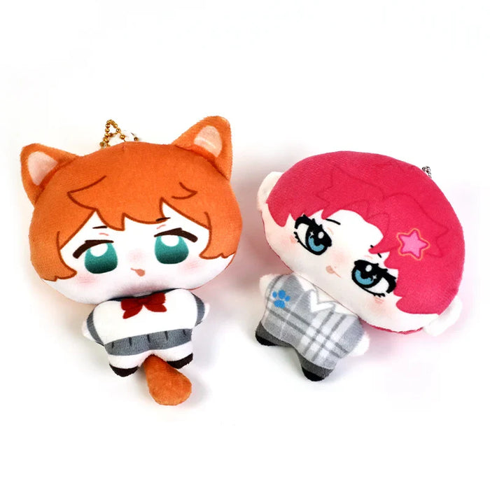Two custom plush keychain dolls with anime faces, one with cat ears and one with red hair.