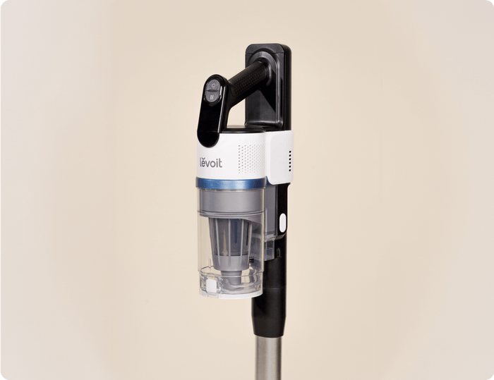 Close-up side view of Levoit AERO™ cordless vacuum handle and dustbin docked on the auto-empty station