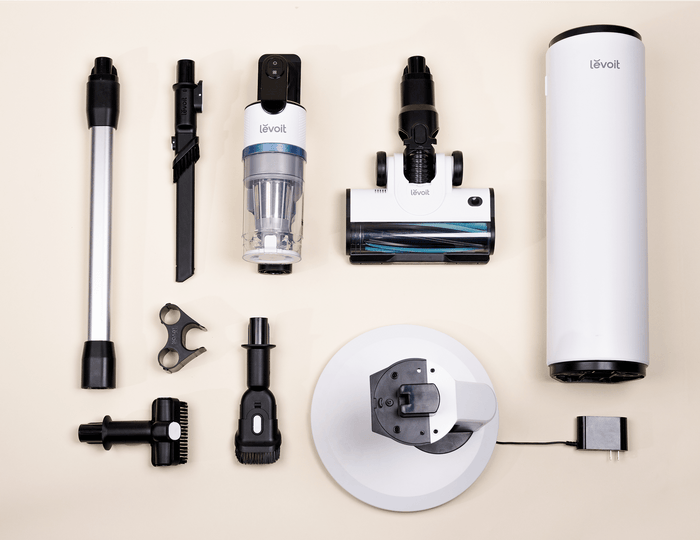Levoit AERO cordless vacuum parts, accessories, and auto-empty station components arranged flat.