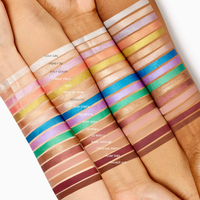 Shimmering gold Walk of Fame Shadow Stix swatch glows across three forearms, lined with other rainbow shades to show pigment and finish; ColourPop Shadow Stix displayed on light, medium, and deep skin tones for shade comparison.